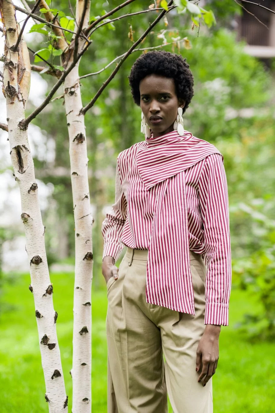 Woman wearing the Zizou Top sewing pattern from Fibre Mood on The Fold Line. A blouse pattern made in poplin, viscose or lyocell twill, silk or satin, or light crepe fabric, featuring an integrated scarf at the neckline and long sleeves with cuffs. 