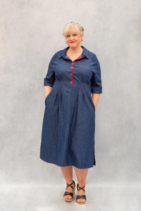 Woman wearing the Zoe Dress sewing pattern from Emporia Patterns on The Fold Line. A shirt dress pattern made in cotton, poplin, linen, linen blends, lawn, chambray, lighter weight denim, viscose challis, or needlecord fabric, featuring a collar with a stand, front button placket, raglan sleeves, pleats at the waist, cutaway pockets, and side splits at the hem.