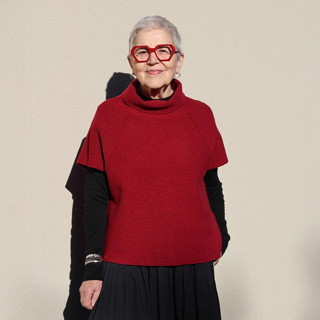 Woman wearing the Zoey Slipover sewing pattern from Tessuti Fabrics on The Fold Line. A top pattern made in boiled wool, boiled viscose/wool, or ponti knit fabric, featuring a boxy fit, turtleneck, and short raglan sleeves.