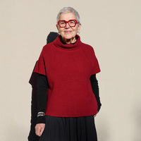 Woman wearing the Zoey Slipover sewing pattern from Tessuti Fabrics on The Fold Line. A top pattern made in boiled wool, boiled viscose/wool, or ponti knit fabric, featuring a boxy fit, turtleneck, and short raglan sleeves.
