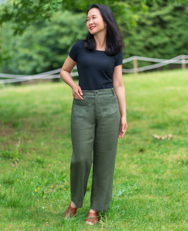Woman wearing the Zubiri Trousers sewing pattern from Itch to Stitch on The Fold Line. A trousers pattern made in linen, linen blend, tencel/lyocell twill, or wool blend fabric, featuring a natural (high) waist, fly front, front and back patch pockets, and wide leg.