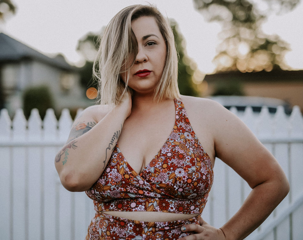 Woman wearing the Superstar Bra sewing pattern from Waves & Wild on The Fold Line. A bra pattern made in cotton/Lycra jersey or athletic polyester/Lycra jersey fabrics, featuring a crossover back, jersey under bust band and broad shoulder straps.