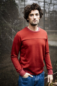 Man wearing the Calvin Jumper sewing pattern from Fibre Mood on The Fold Line. A jumper pattern made in sweatshirting, French terry or neoprene fabrics, featuring ribbed waistband and cuffs, round neck, and additional front seaming.