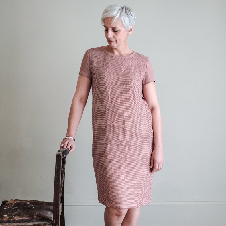 Woman wearing The Camber Dress sewing pattern from Merchant & Mills on The Fold Line. A dress pattern made in light linens, cottons, fine wool, silk or lightweight denim fabrics, featuring a tapered A-line silhouette, short fitted sleeves, round neck, kne