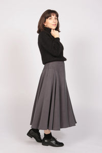 Woman wearing the Averse Skirt sewing pattern from Camimade on The Fold Line. A skirt pattern made in viscose, tencel, linen, cotton lawn or chambray fabrics, featuring a side invisible zip, midi length finish, curved waistband and a full skirt giving the