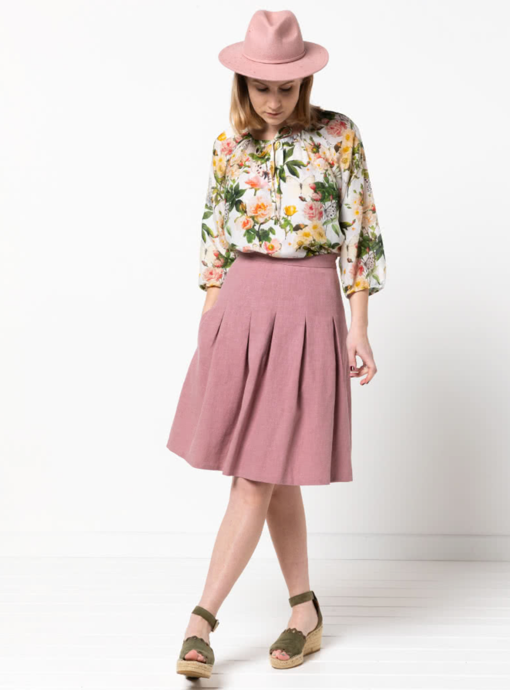 Women wearing the Candice Skirt sewing pattern from Style Arc on The Fold Line. A skirt pattern made in scuba, ponte, linen or cotton fabrics, featuring inverted pleats, side zip, knee length and side pocket.