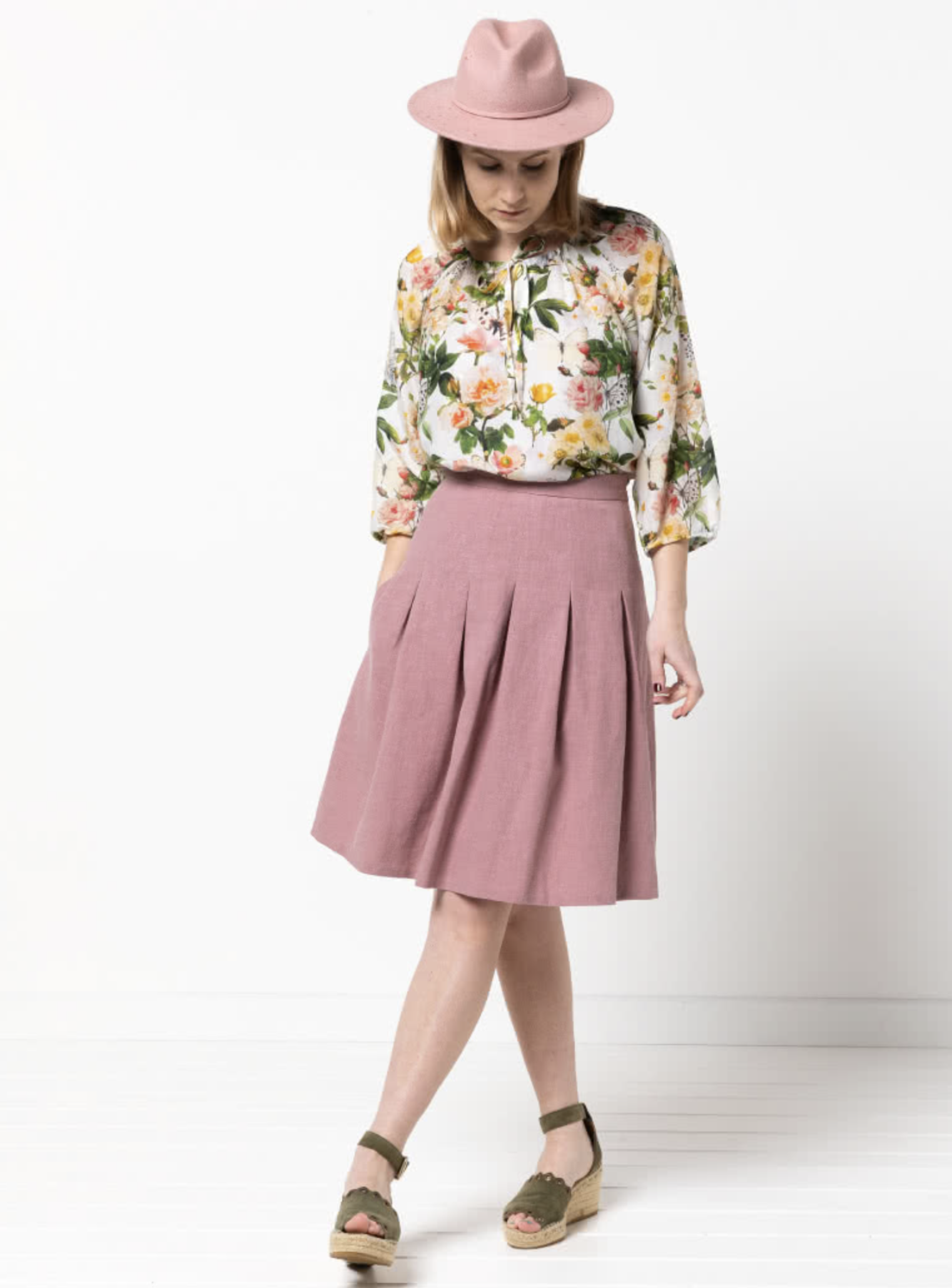 Women wearing the Candice Skirt sewing pattern from Style Arc on The Fold Line. A skirt pattern made in scuba, ponte, linen or cotton fabrics, featuring inverted pleats, side zip, knee length and side pocket.