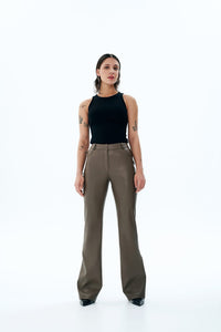Woman wearing the Candice Trousers sewing pattern from Vikisews on The Fold Line. A trouser pattern made in faux leather, faux suede or leather fabrics, featuring a close-fit, flared leg, below ankle length, front slash pockets, back yoke, back patch pock