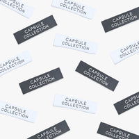 Photo showing ‘Capsule collection’ Labels from Kylie & The Machine on The Fold Line. A washable, durable, and non-scratchy label. Included are 6 woven labels: 3 x white background with black text and 3 x black background with white text background. They a