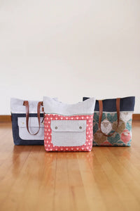 Photo showing the Caravan Tote and Pouch sewing pattern from Noodlehead on The Fold Line. A tote and pouch pattern made in canvas (cotton, waxed or blended), denim, twill or home dec fabrics, featuring a tote with exterior zippered pocket, exterior flap p