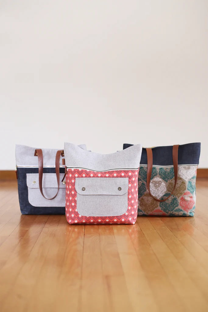 Photo showing the Caravan Tote and Pouch sewing pattern from Noodlehead on The Fold Line. A tote and pouch pattern made in canvas (cotton, waxed or blended), denim, twill or home dec fabrics, featuring a tote with exterior zippered pocket, exterior flap p