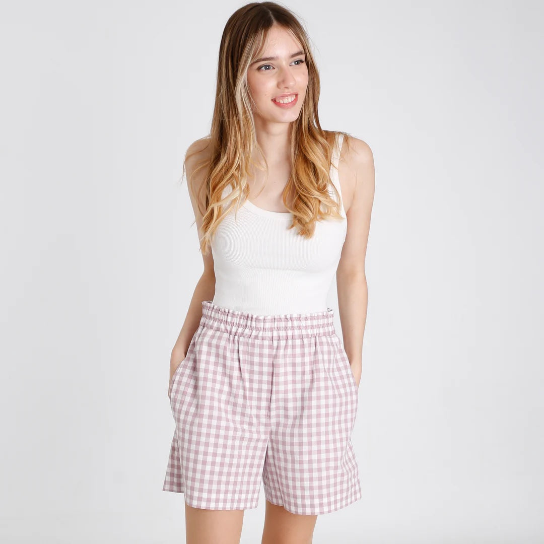 Woman wearing the Carla Shorts sewing pattern from Fieldwork Patterns on The Fold Line. A shorts pattern made in cottons, cotton mixes, linen, linen mixes or lightweight denim fabrics, featuring a pull-on style, side seam pockets, back patch pockets, elas