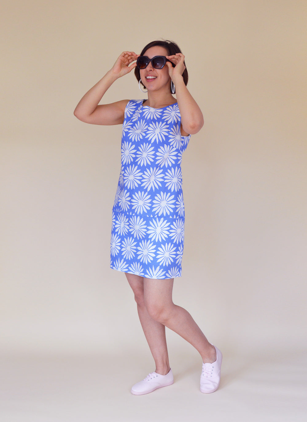 Woman wearing the Carnaby Dress sewing pattern from Nina Lee on The Fold Line. A sleeveless shift dress pattern made in lightweight denim, corduroy, lightweight wool, cotton sateen or chambray fabrics, featuring in-seam pockets, exposed zip at the centre 