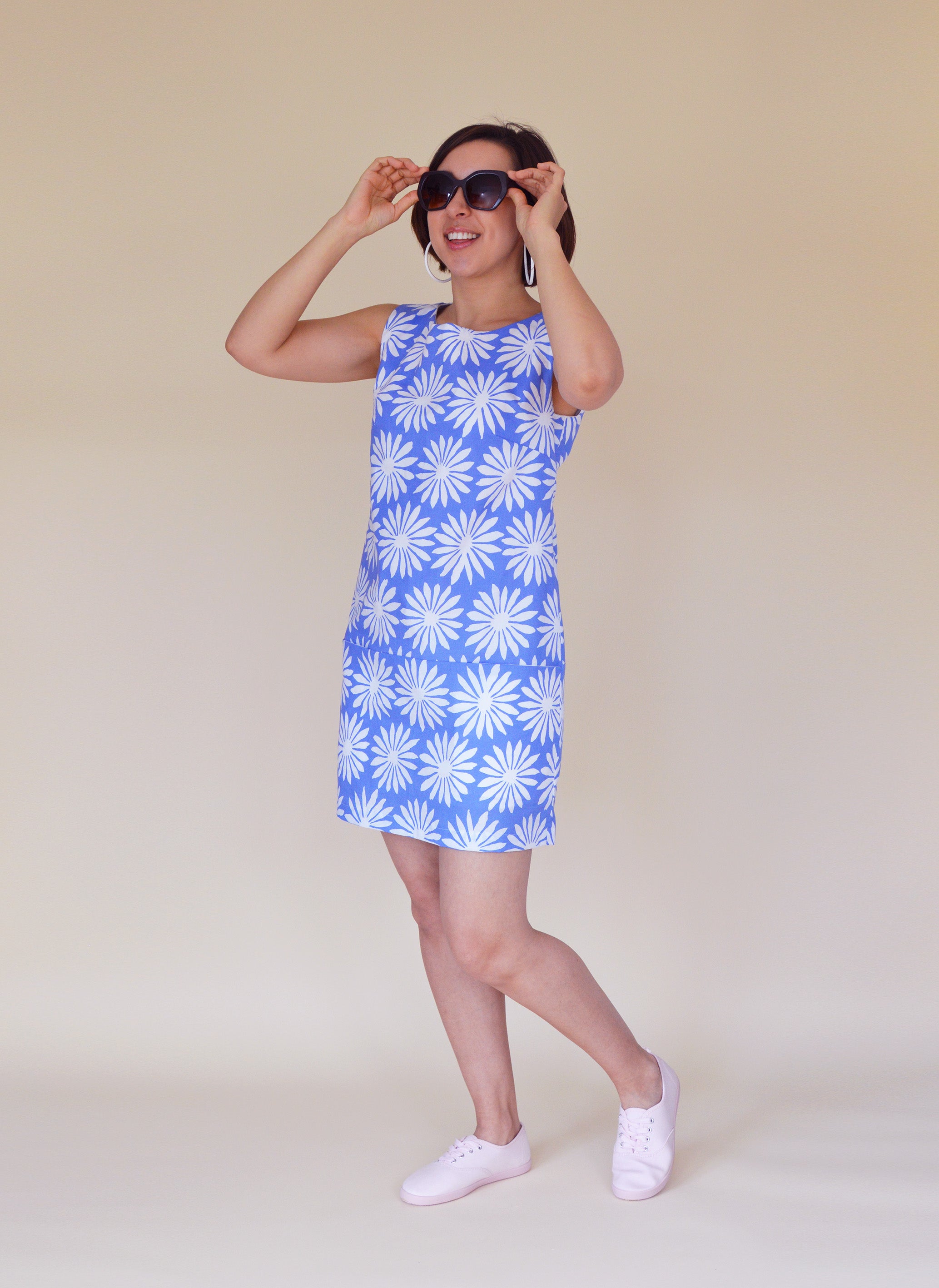 Woman wearing the Carnaby Dress sewing pattern from Nina Lee on The Fold Line. A sleeveless shift dress pattern made in lightweight denim, corduroy, lightweight wool, cotton sateen or chambray fabrics, featuring in-seam pockets, exposed zip at the centre 