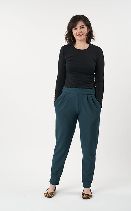 Woman wearing the Carrie Trousers sewing pattern from Sew Over It on The Fold Line. A trouser pattern made in rayon, viscose, crepe, lightweight linen or cotton lawn fabrics, featuring a loose-fit through the legs, slightly tapered towards the ankle, flat