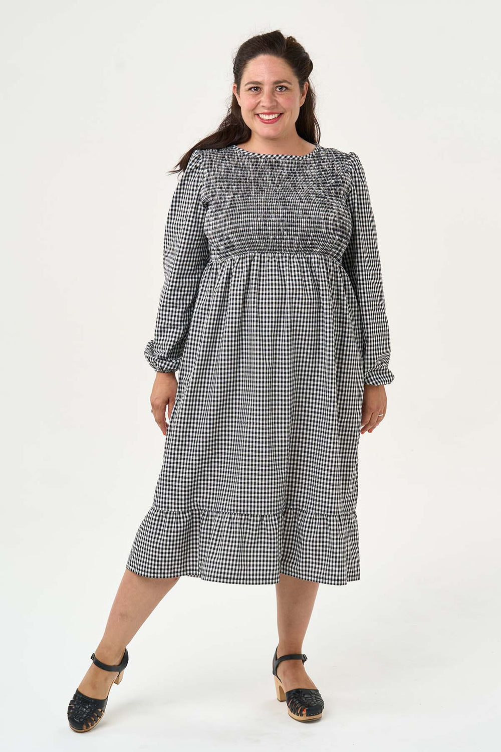 Woman wearing the Cassie Dress sewing pattern from Sew Over It on The Fold Line. A dress pattern made in cotton lawn, cotton poplin, viscose, rayon or crepe fabrics, featuring a fully shirred bodice, bound round neck, gathered tier skirt, full length puff