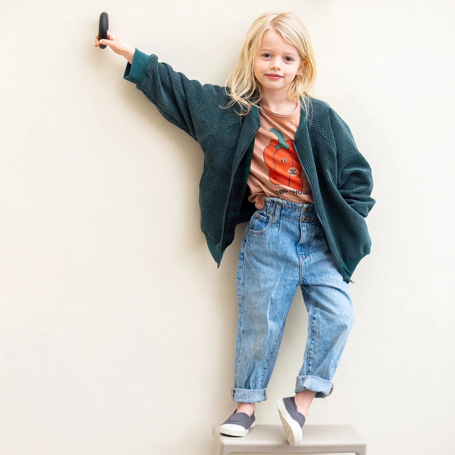 Child wearing the Baby/Child/Teen Cato Bomber Jacket sewing pattern from WISJ on The Fold Line. A jacket pattern made in canvas, oilskin, cotton or softshell, french terry, corduroy or knitted fabrics, featuring raglan sleeves, pockets, long sleeves with 