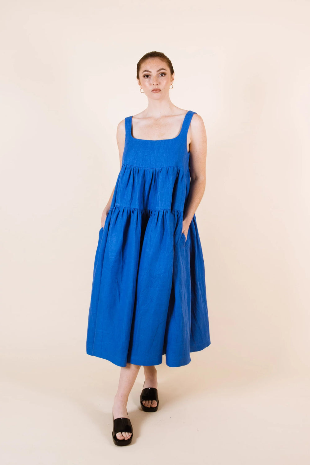 Women wearing the Celestia Dress sewing pattern from Papercut Patterns on The Fold Line. A sun dress pattern made in cotton, linen or rayon fabrics, featuring three tiers of voluminous fabric, midi length, in-seam pockets, square neckline and shoulder str
