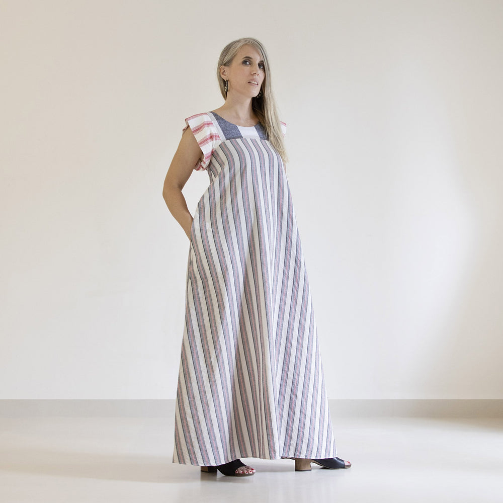 Woman wearing the Celestial Dress sewing pattern from Pattern Fantastique on The Fold Line. A dress pattern made in viscose, silks, linen, cotton to denim fabrics, featuring a round neck, grown on short sleeves, maxi length, no closings, wide A-line silho
