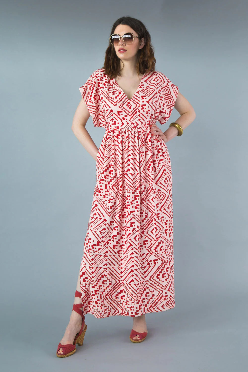 Woman wearing the Charlie Caftan sewing pattern by Closet Core Patterns. A dress pattern made in linen, chambray, silk, chiffon or rayon crepe fabric featuring a deep V-neckline, short dolman sleeves, roomy pockets and a back waist tie.