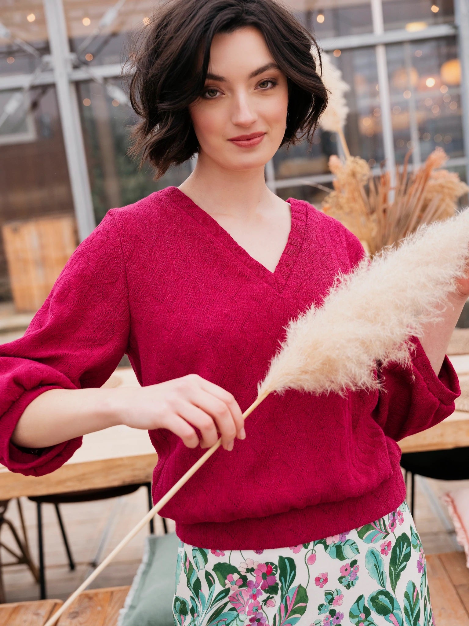 Woman wearing the Charlie Sweater sewing pattern from Atelier Jupe on The Fold Line. A jumper dress pattern made in sweatshirting, French terry or knitted fabrics, featuring a V-neckline and three-quarter length gathered sleeve.