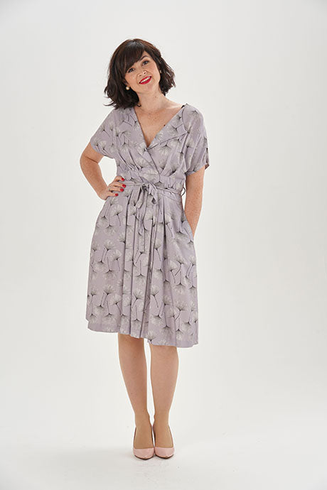 Woman wearing the Charlotte Dress sewing pattern from Sew Over It on The Fold Line. A dress pattern made in crepe, lightweight wool, linen or linen viscose mix fabrics, featuring a faux wrap-over front with pleats, lapel collar, V-neck, grown-on short sle