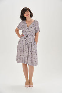Woman wearing the Charlotte Dress sewing pattern from Sew Over It on The Fold Line. A dress pattern made in crepe, lightweight wool, linen or linen viscose mix fabrics, featuring a faux wrap-over front with pleats, lapel collar, V-neck, grown-on short sle