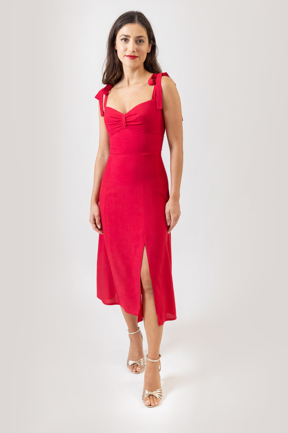 Women wearing the Chloe Dress sewing pattern from Sew Love Patterns on The Fold Line. A dress pattern made in viscose, tencel, crepe, velvet, satin rayon and cotton fabrics, featuring tied shoulder straps, close fitting, midi length with front slit, low s