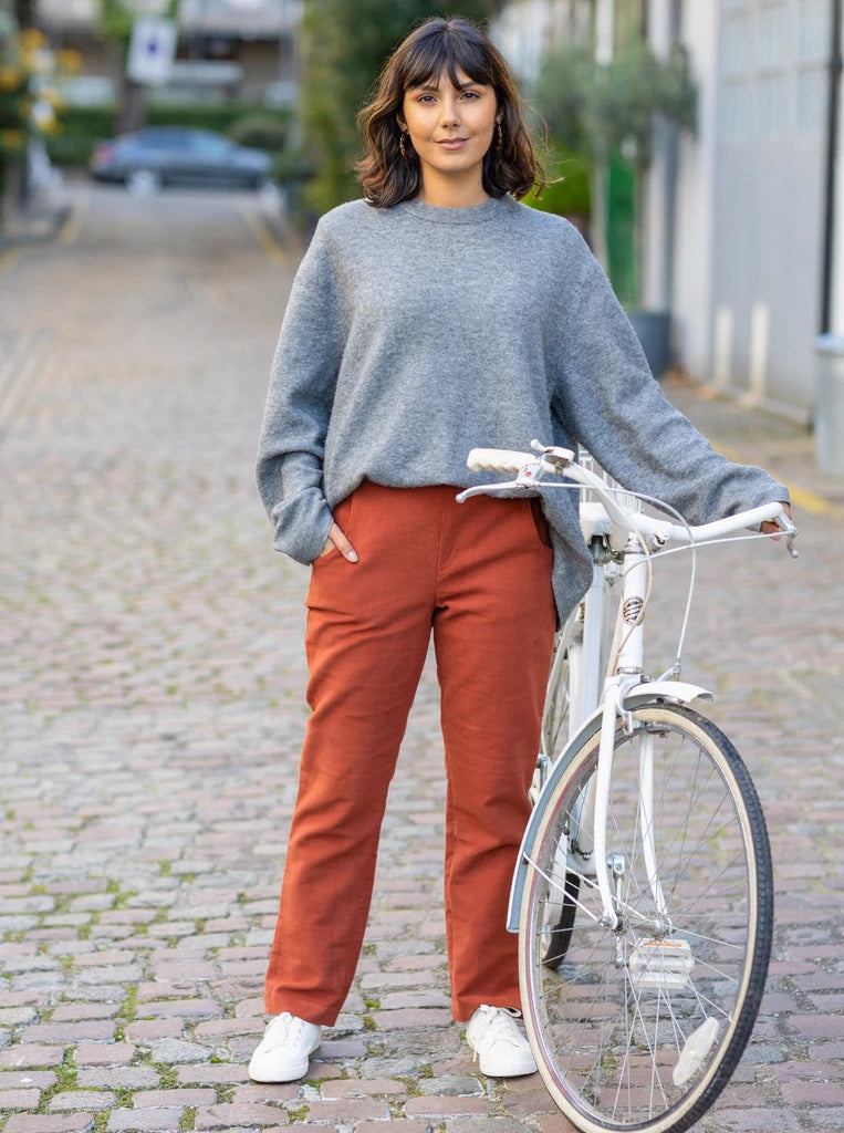 Woman wearing The City Trousers sewing pattern from The Avid Seamstress on The Fold Line. A trouser pattern made in medium weight with slight stretch fabrics, featuring a slim fit, side pockets, side slit at the leg hem, narrow waistband and invisible bac