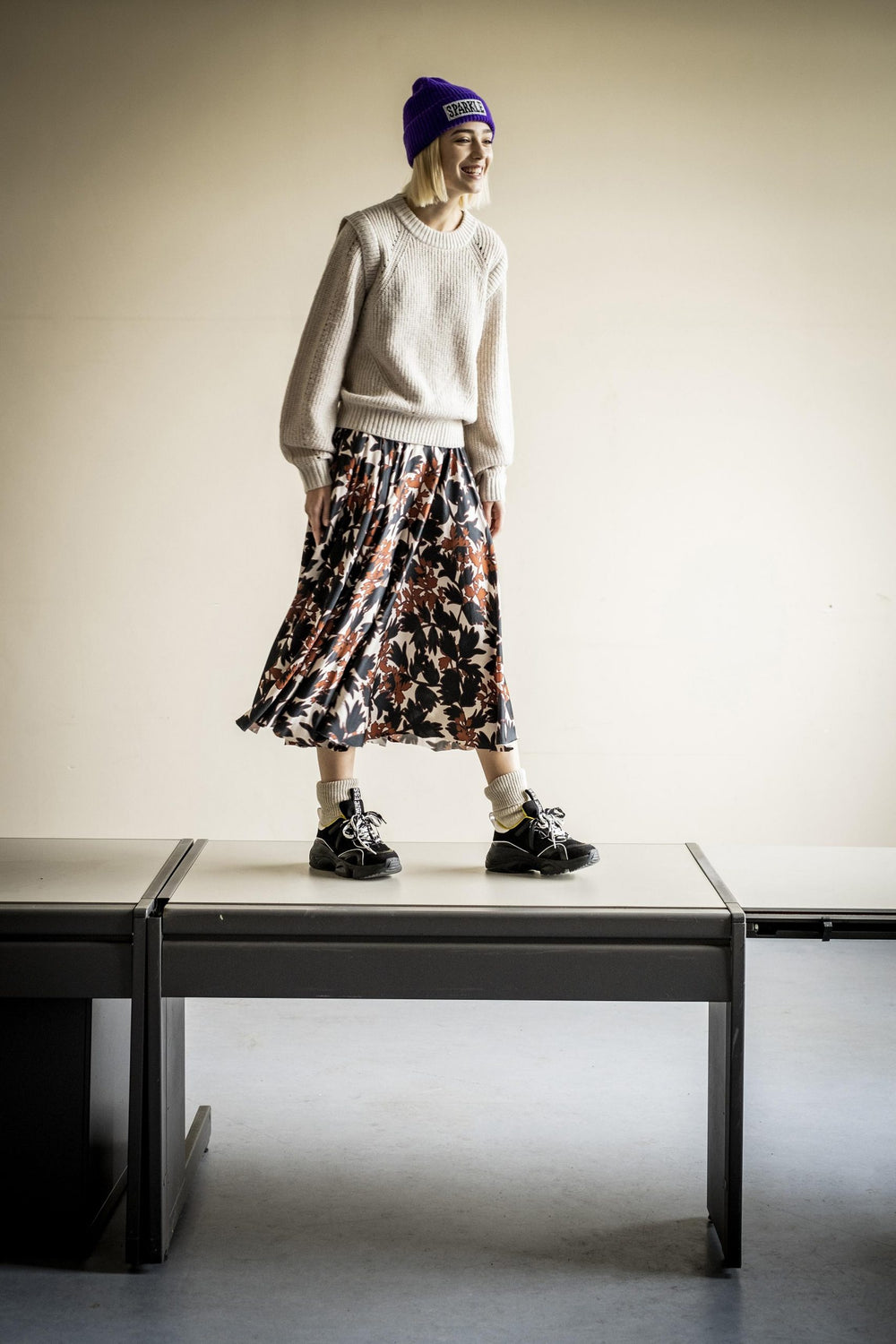 Woman wearing the Claudie Skirt sewing pattern from Fibre Mood on The Fold Line. A circle skirt pattern made in non-stretch woven fabrics, featuring a high waist, straight waistband, back invisible zip closure, side seam pockets and mid-length hem.