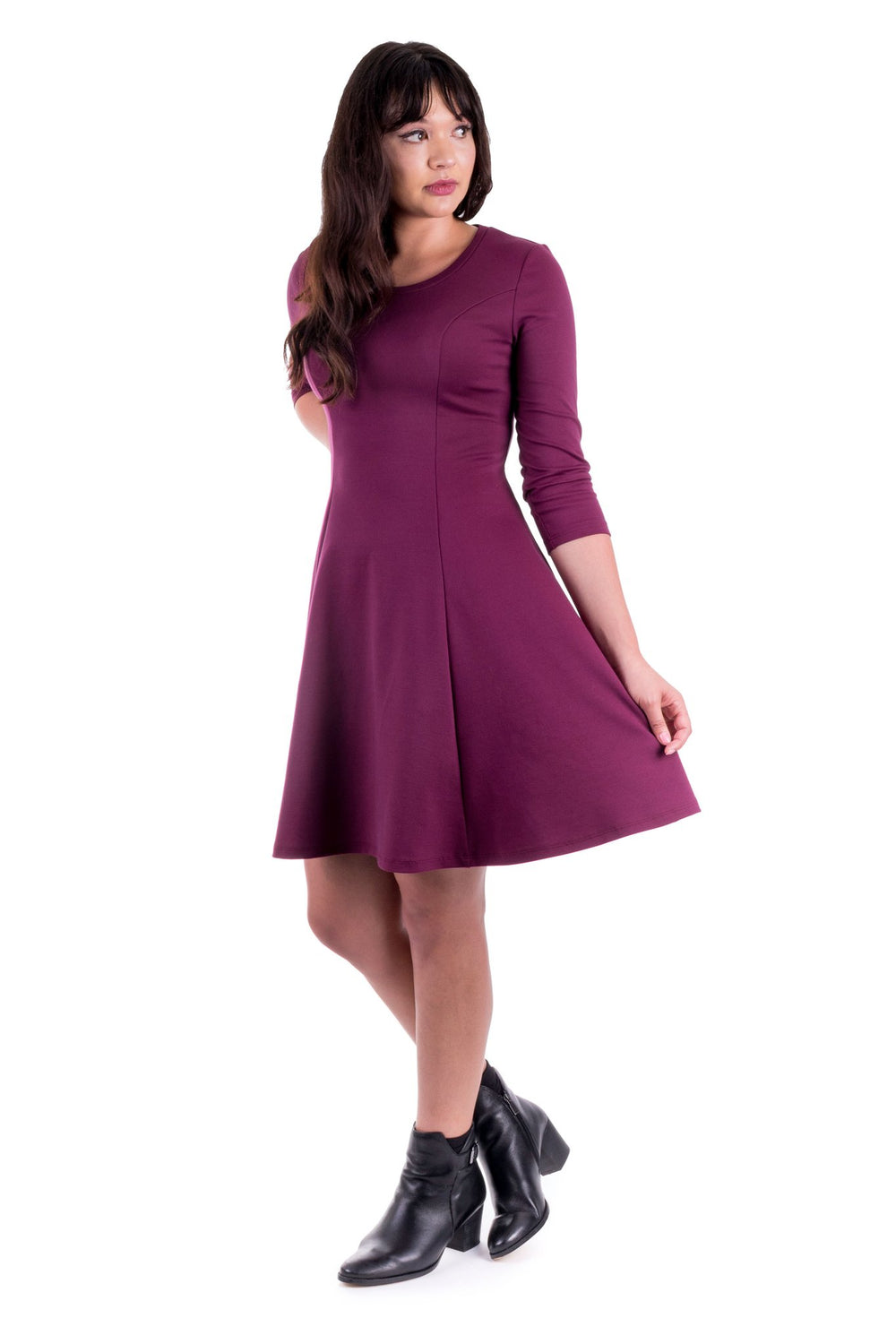 Woman wearing the Clementine Knit Dress sewing pattern by Forget-me-not Patterns. A knit dress pattern made in cotton jersey, viscose jersey, merino jersey, light to medium-weight double knits, or sweater knit fabrics, featuring an above knee finish, flar