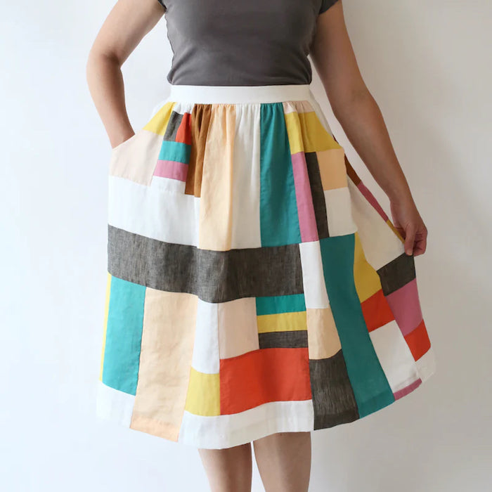 Woman wearing the Cleo Skirt sewing pattern from Made by Rae on The Fold Line. A skirt pattern made in lawn, voile, double gauze, poplin, shirting, rayon challis, sateen, silk, quilting cotton, linen, or cotton-linen blend fabrics, featuring a flat-front 