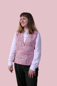 Woman wearing the Clove Vest sewing pattern from Charlotte Emma Patterns on The Fold Line. A knit vest top pattern made in sweatshirting, french terry, quilted jersey or ponte fabrics, featuring a wide neckband ending in a V-neck and deep hem band with si