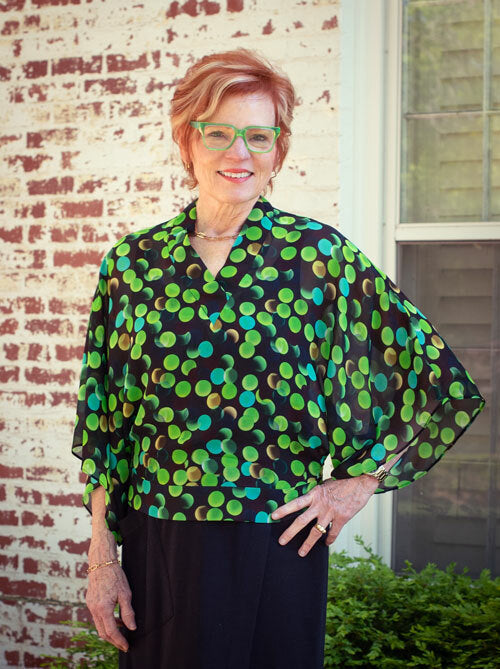 Woman wearing the Coco Blouse sewing pattern from The Sewing Workshop on The Fold Line. A top pattern made in crepe de chine, lightweight cotton, cotton voile, lightweight linen, rayon or light to mid-weight knit fabrics, featuring a loose-fitting bodice,