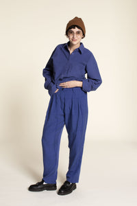 Woman wearing the Cocoon Pants sewing pattern from Wardrobe by Me on The Fold Line. A trouser pattern made in cotton twill, denim or corduroy fabrics, featuring a relaxed fit, tapered legs, contoured waistband, fly front zipper, deep front pleats, side po