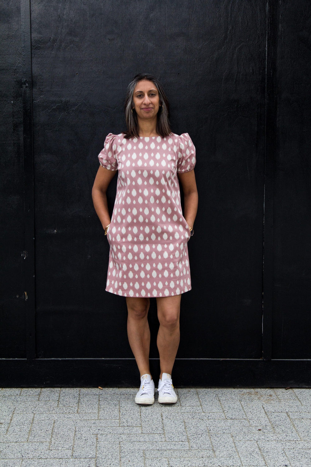 Woman wearing the Corey Dress pattern from Make With Mandi on The Fold Line. A shift dress pattern made in cotton, linen, viscose, linen blends or poly blend fabrics, featuring bust darts, boat neck, short puffed sleeves with elasticated cuff, inseam pock