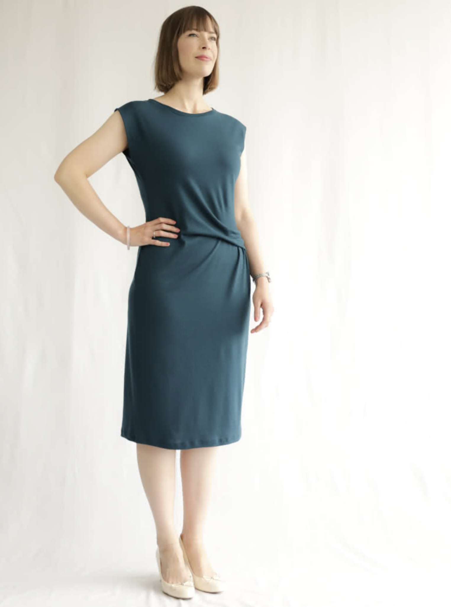 Woman wearing the Corina Knit Dress sewing pattern from Style Arc on The Fold Line. A knit dress pattern made in knit jersey, baby wool or marino knit fabrics, featuring a pull-on style, fitted with slight negative ease, round neck with neckband, extended