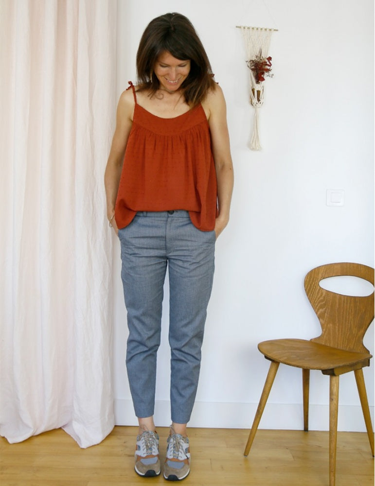 Woman wearing the Crépuscule Tank Top sewing pattern from Atelier Scämmit on The Fold Line. A strappy top pattern made in batiste, chiffon, veil, crepe or viscose fabrics, featuring spaghetti tie straps, low rounded neckline, gathered yoke and relaxed fit