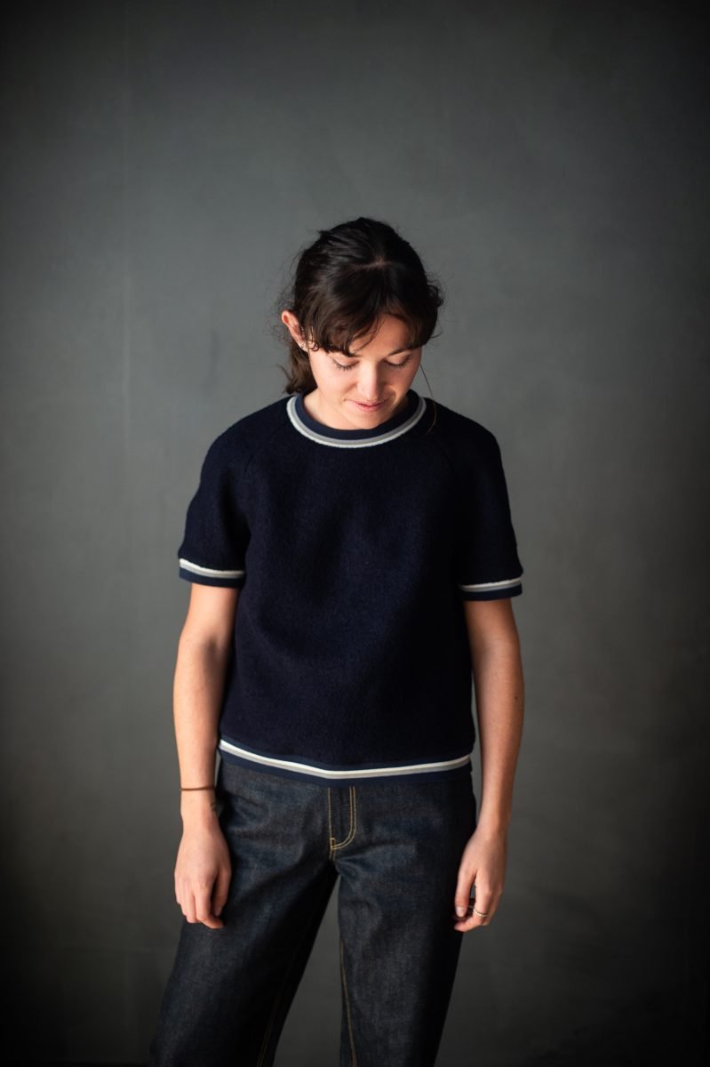 Woman wearing the Fielder Top sewing pattern from Merchant & Mills on The Fold Line. A top pattern made in linen, soft cottons, lightweight denims, wools, light flannel or crepe fabrics, featuring an addition of short sleeves and higher neckline.
