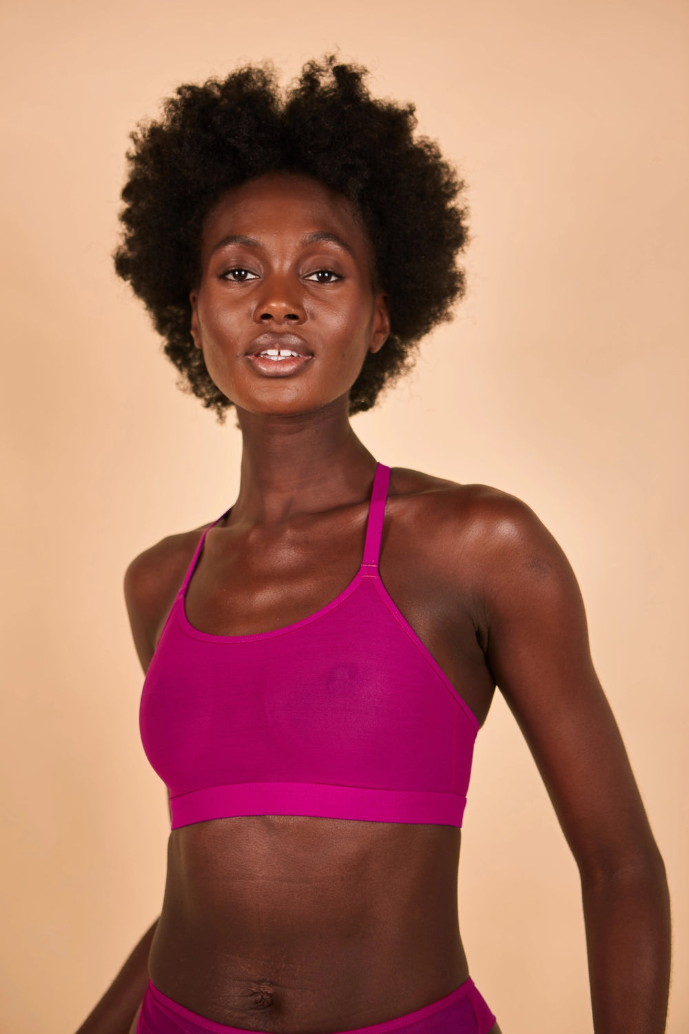 Woman wearing the Crop Bra sewing pattern from The New Craft House on The Fold Line. A bralette pattern made in stretch mesh, cotton jersey, lingerie jersey and lace fabrics, featuring a soft-cup, full front coverage, convertible racer back straps, hook a