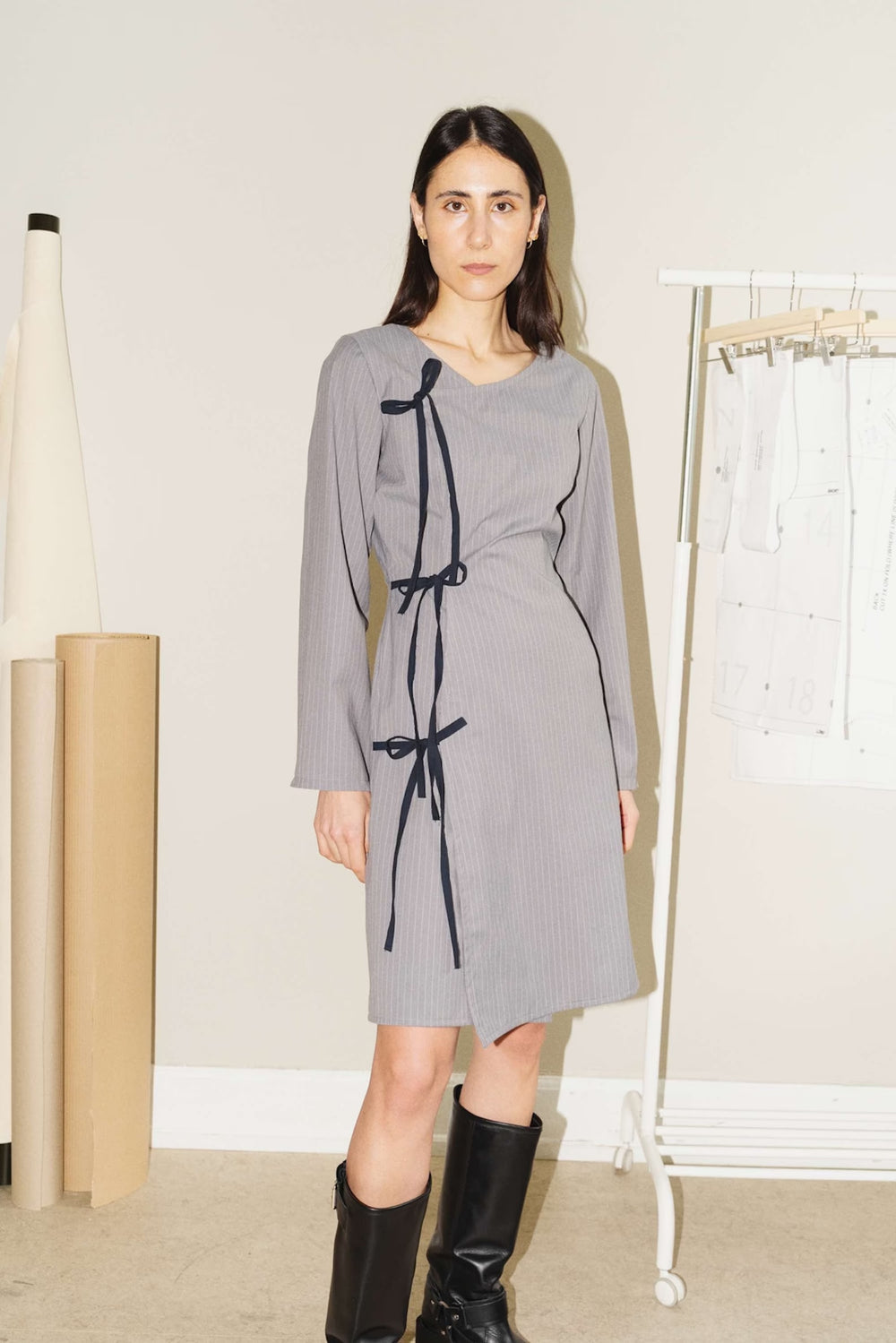 Woman wearing the Crossover Dress & Cone Sleeve sewing pattern from Puff and Pencil on The Fold Line. A wrap dress pattern made in poplin, woven viscose, lightweight denim and lightweight canvas fabrics, featuring a single inner tie, three outer ties, V-n