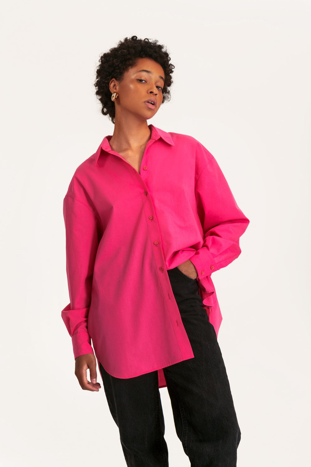 Woman wearing the Cynthia Blouse sewing pattern from Vikisews on The Fold Line. A blouse pattern made in shirting, dress weight cotton, linen, poplin, lightweight denim, cupro, viscose, modal or babycord fabrics, featuring an oversized fit, lined back yok