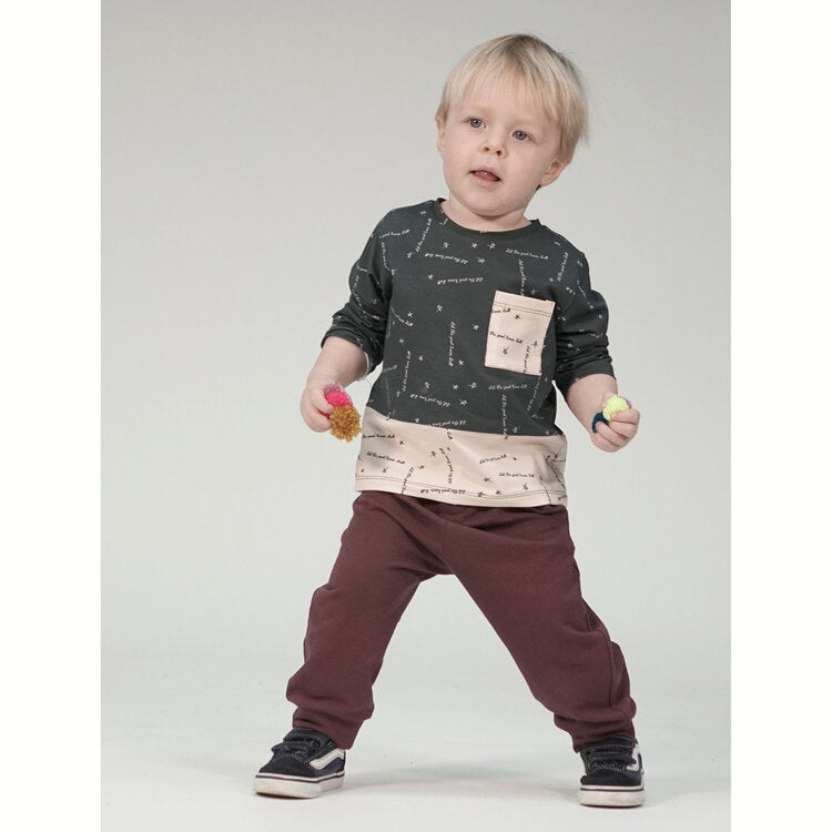 Child wearing the Child Blake T-shirt sewing pattern from Pattern Paper Scissors on The Fold Line. A Tee pattern made in jersey, sweat, terry, stretch crepe or knit fabrics, featuring a, slouchy fit, crewneck, long sleeves, patch chest pocket and deep con