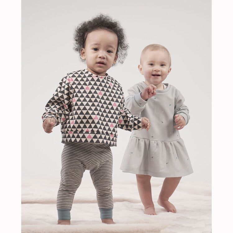 Toddlers wearing the Sparrow Sweatshirt & Dress sewing pattern from Pattern Paper Scissors on The Fold Line. A sweatshirt and dress pattern made in jersey, knit, or cotton elastane fabrics, featuring a relaxed fit, round neck, full length sleeves, dress h