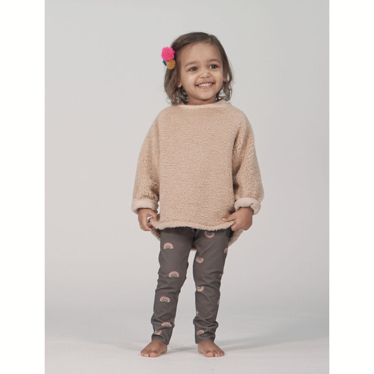 Child wearing the Aspen Sweatshirt sewing pattern from Pattern Paper Scissors on The Fold Line. A sweatshirt pattern made in jersey, sweat, terry, stretch crepe or knit fabrics, featuring a slouchy fit, long raglan sleeves with cuffs, round neck with knit
