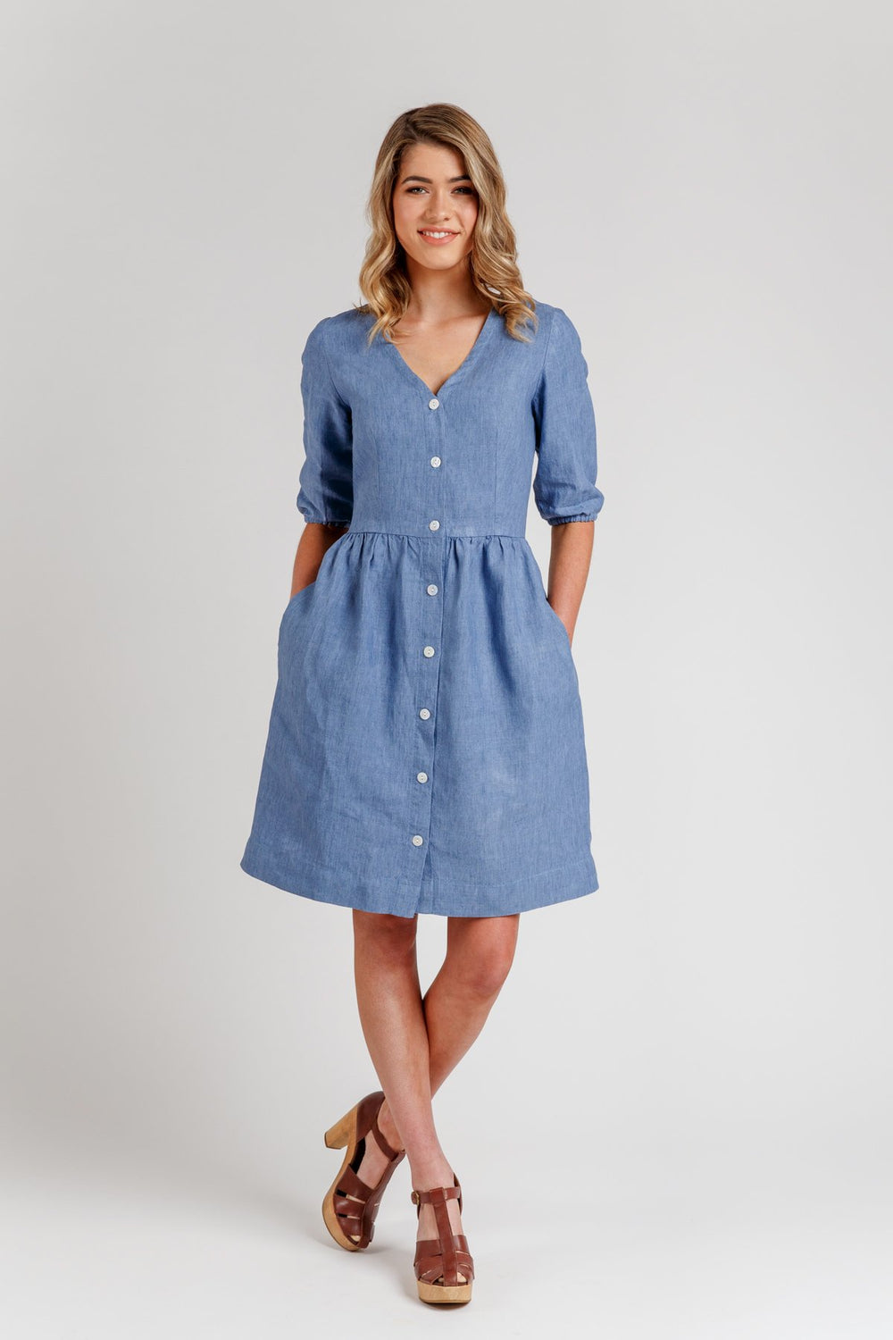Woman wearing the Darling Ranges Dress sewing pattern from Megan Nielsen on The Fold Line. A shirt dress pattern made in silk, crepe de chine, lightweight cottons (voile, batiste, lawn, chambray), lightweight linen and rayon fabrics, featuring a V-neck, b