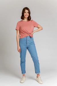 Woman wearing the Dawn Jeans sewing pattern from Megan Nielsen on The Fold Line. A jeans pattern made in rigid denim, linen, twill, or corduroy fabrics, featuring a high waist, button fly, belt loops, back patch pockets, front pockets, close fit through w