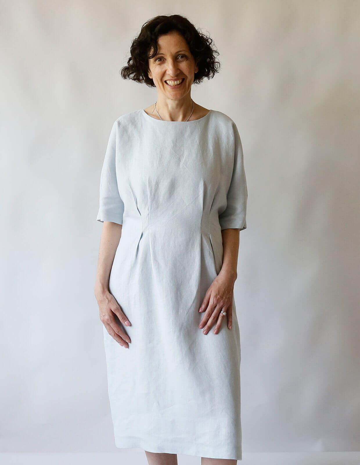 Woman wearing the Day Dress sewing pattern from The Maker’s Atelier on The Fold Line. A dress pattern made in cotton, linen, denim, chambray, Tencel and viscose fabrics, featuring a relaxed fit, pull-on style, grown on elbow length sleeves, round neck, fr