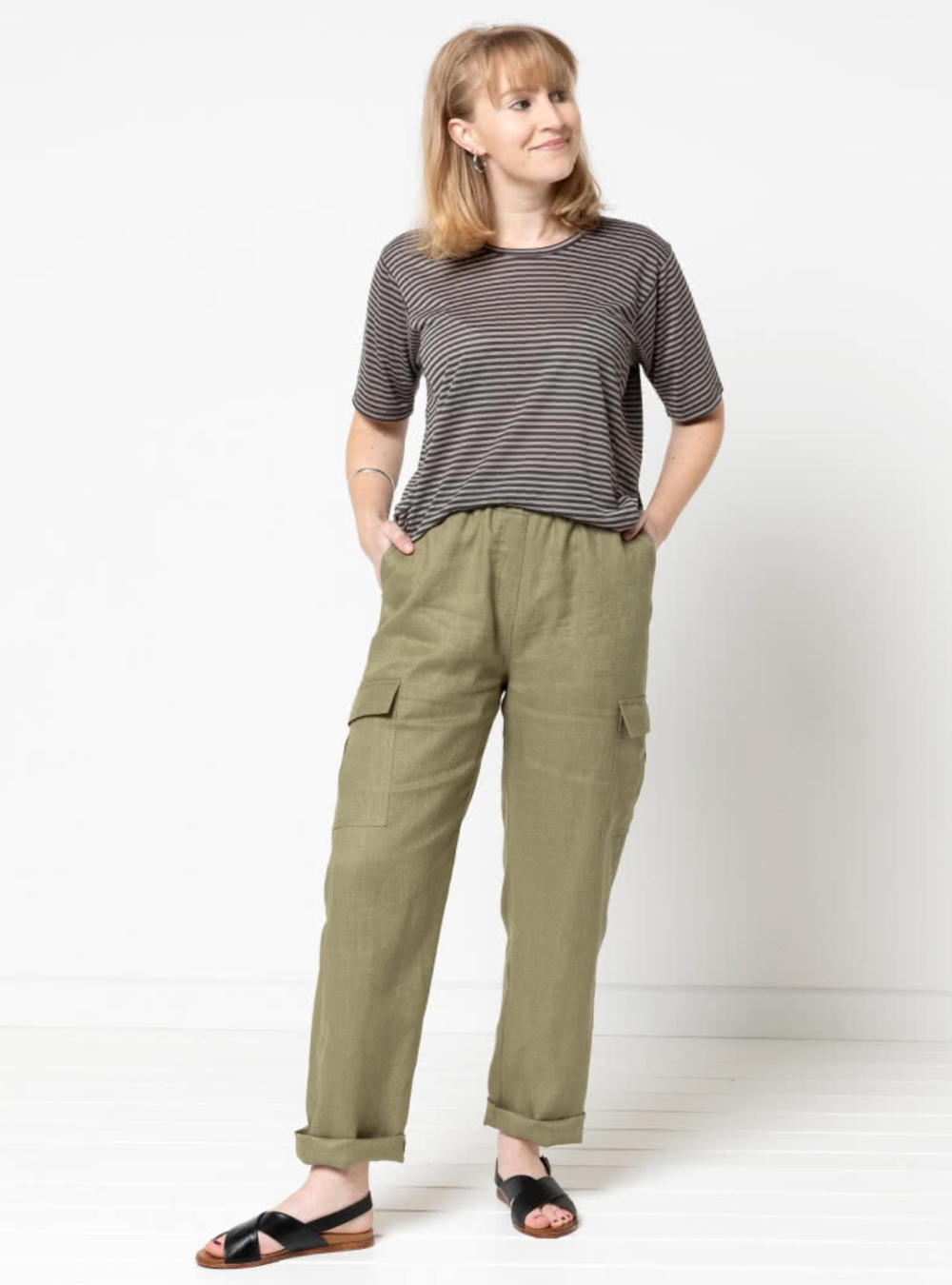 Woman wearing the Delta Cargo Pant sewing pattern from Style Arc on The Fold Line. A cargo trouser pattern made in drill, denim, light wool or washed linen fabrics, featuring a straight leg, elastic waist, faux fly, front slant pockets, back patch pockets