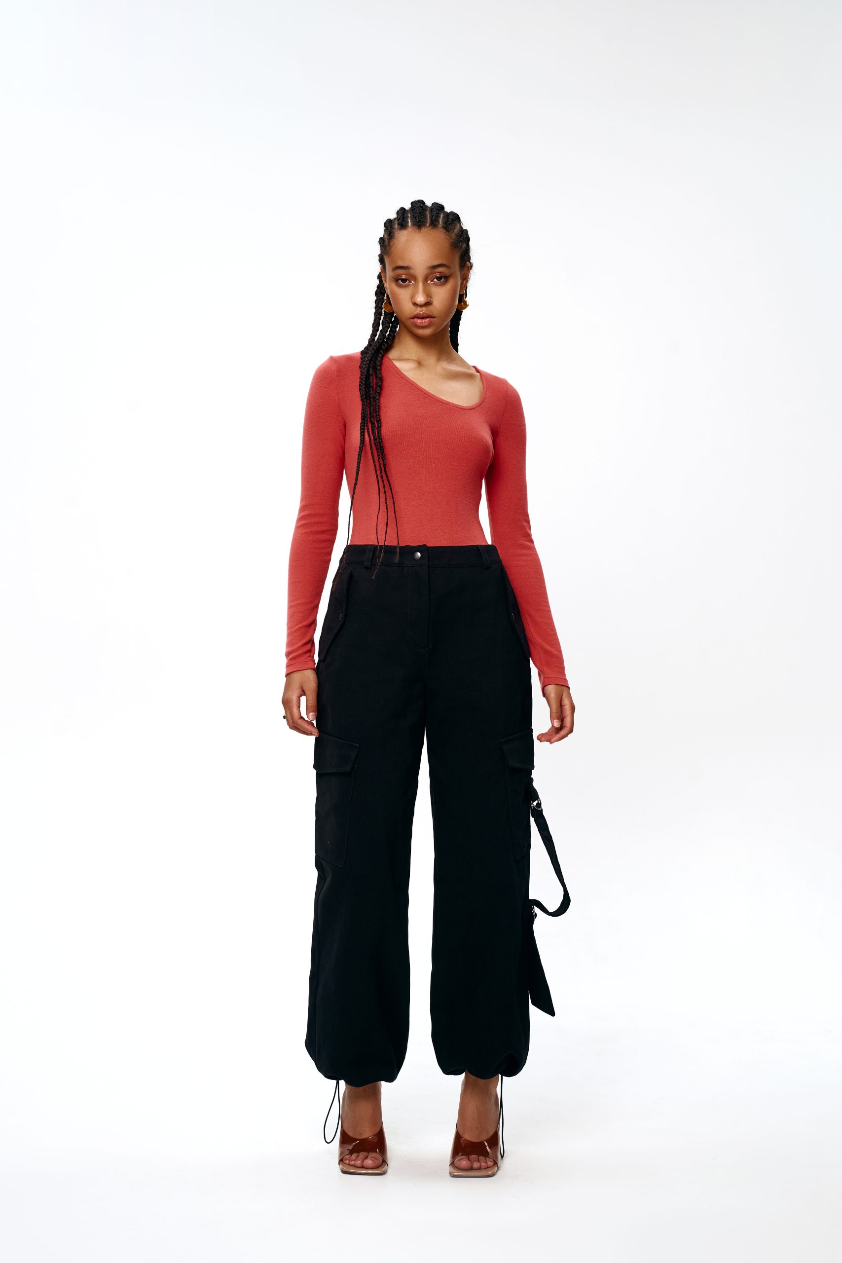 Woman wearing the Deryll Trousers sewing pattern from Vikisews on The Fold Line. A trouser pattern made in twill, denim, or corduroy fabrics, featuring a semi-fit, straight-cut, decorative topstitching, belt loops, front slash pockets with flaps, back yok